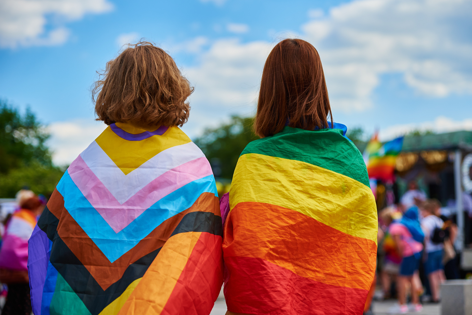 Back of People Wearing LGBT Flags 